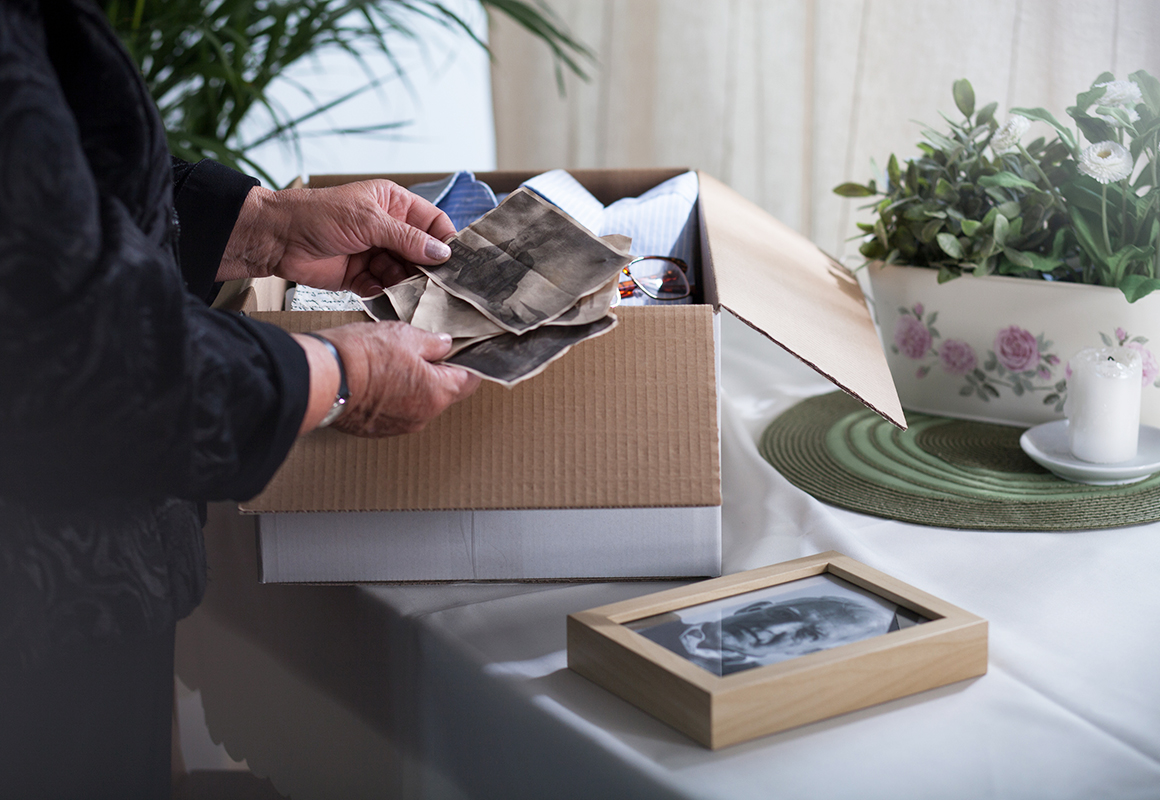 Sorting through old photos in a box